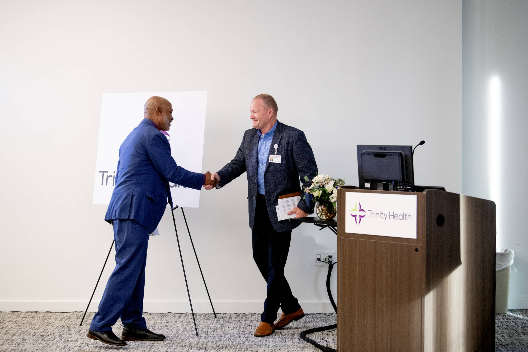 John Selmon, president of Muskegon Community College, left, shakes hands with Gary Allore, president of Trinity Health Muskegon, Shelby and Grand Haven, during the event.
